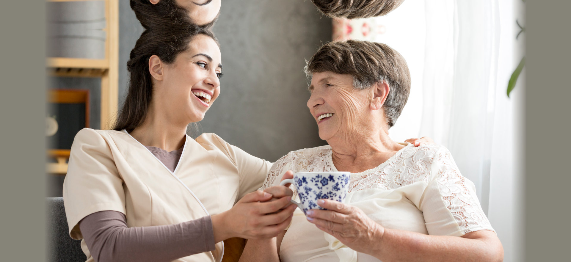 caregiver and an elderly with a cup