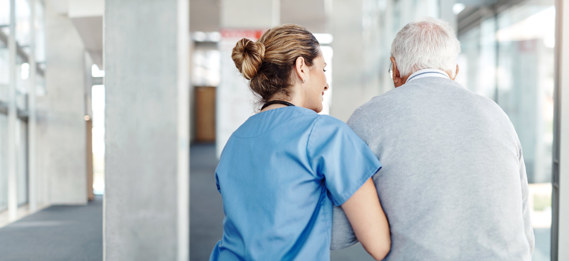 caregiver assisting a senior man