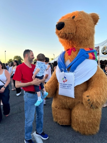 a baby playing with the mascot